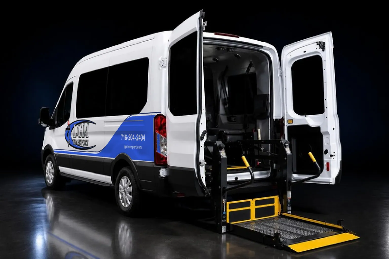 LGM Transport wheelchair van with its rear doors open and the platform lift lowered